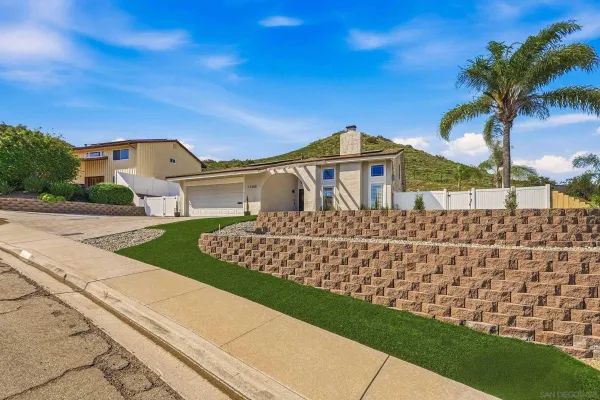 a living room with furniture fireplace and a large window