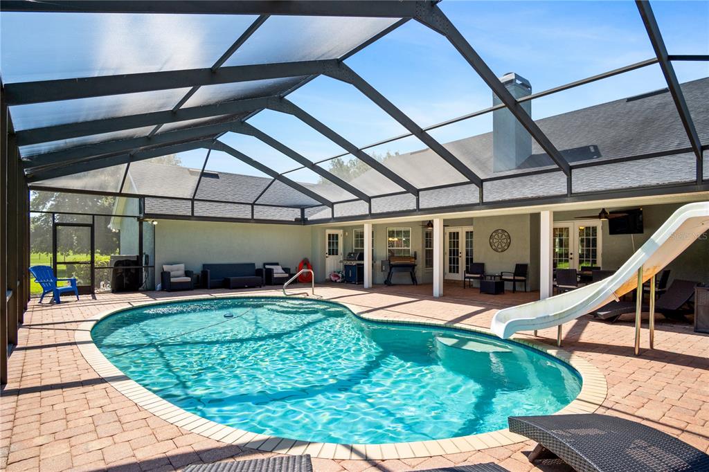 9045 Lake Hatchineha Road Kissimmee, FL 34759 - Photo 11 of 47 a view of a backyard with sitting area