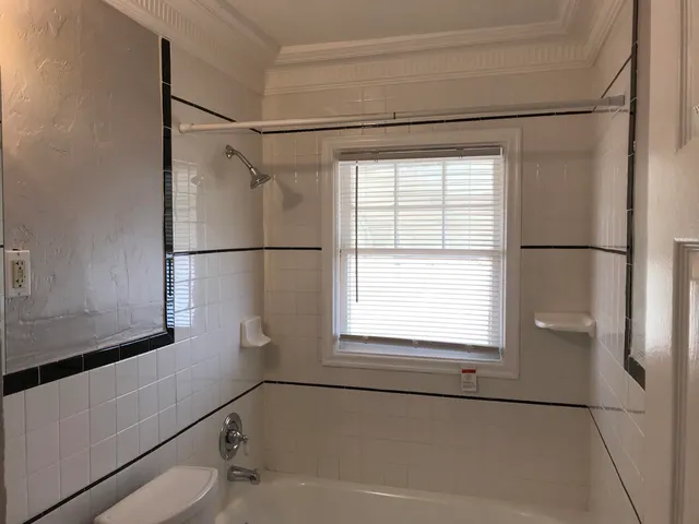 a bathroom with a bathtub and a window