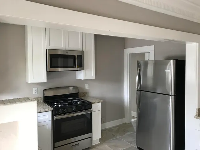a kitchen with a refrigerator stove and microwave