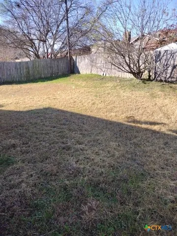 a view of a back yard of the house