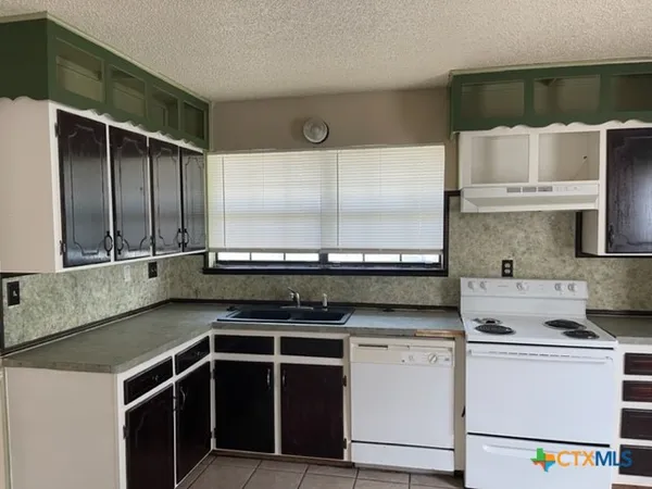 a kitchen with a stove and a microwave