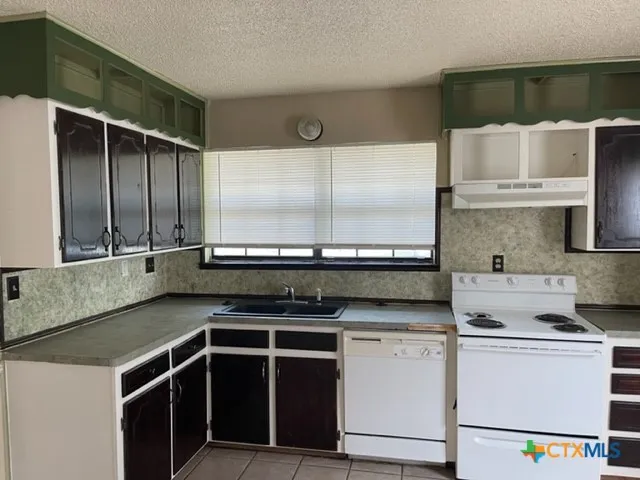 a kitchen with a stove and a microwave