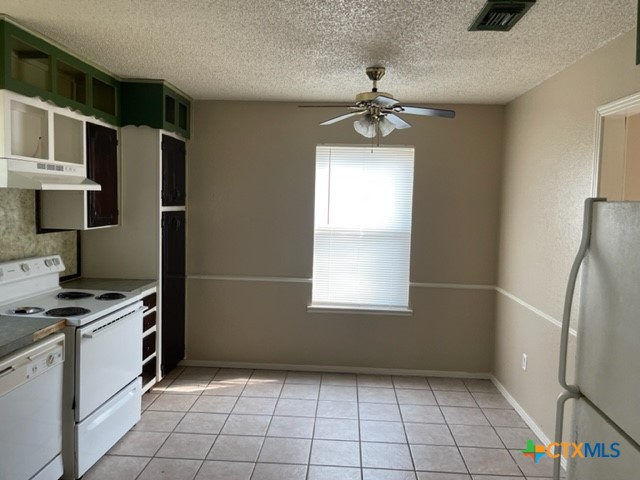 213 Blanket Drive Copperas Cove, TX 76522 - Photo 6 of 14 a kitchen with stainless steel appliances a refrigerator and a stove top oven