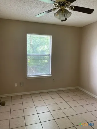 a view of a room with wooden floor and a window
