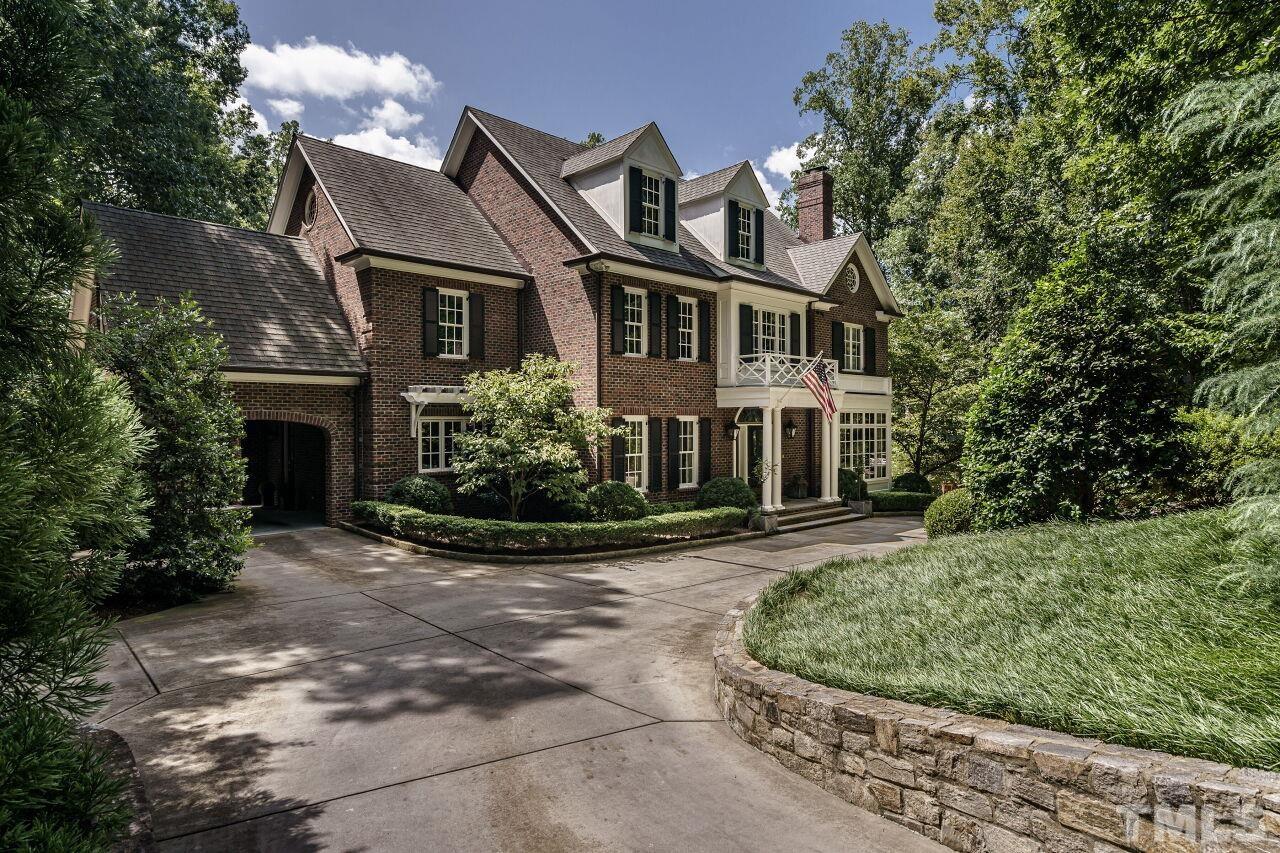 a front view of a house with a yard garage and outdoor seating