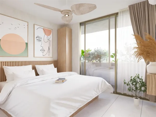 a bedroom with a large bed and a large window