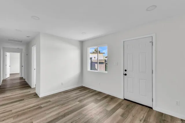 a view of an empty room with wooden floor