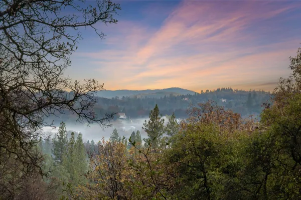 a view of a house with a mountain in the background