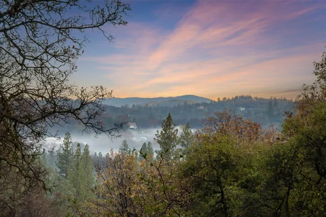 a view of a house with a mountain in the background
