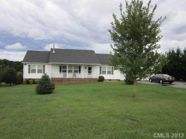 114 Rabbit Highway Harmony, NC 28634 - Photo 13 of 16 a front view of a house with a garden