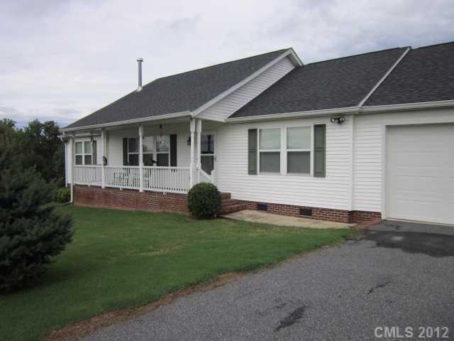 114 Rabbit Highway Harmony, NC 28634 - Photo 14 of 16 a view of a house with a backyard