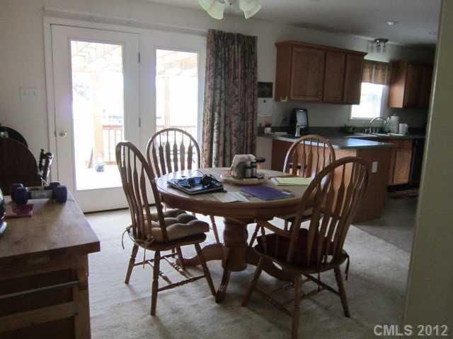 114 Rabbit Highway Harmony, NC 28634 - Photo 15 of 16 a view of a dining room with furniture window and outside view