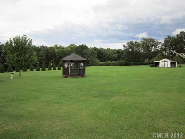 114 Rabbit Highway Harmony, NC 28634 - Photo 16 of 16 a backyard of a house with lots of green space