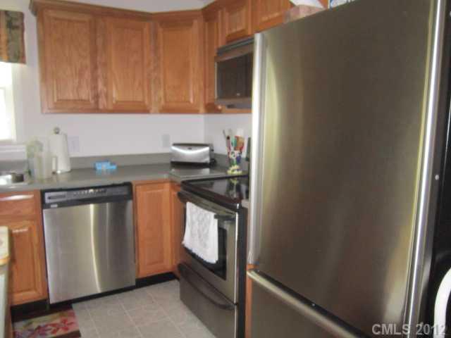 114 Rabbit Highway Harmony, NC 28634 - Photo 5 of 16 a kitchen with stainless steel appliances granite countertop a sink stove and cabinets