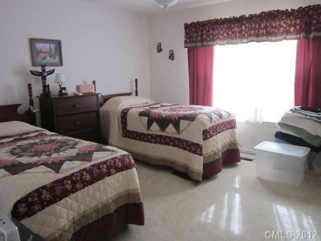 114 Rabbit Highway Harmony, NC 28634 - Photo 7 of 16 a spacious bedroom with a bed and window