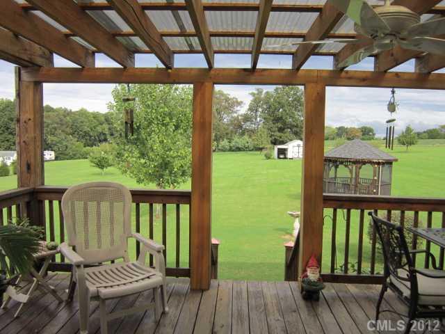 114 Rabbit Highway Harmony, NC 28634 - Photo 9 of 16 a view of a balcony with chairs and wooden floor