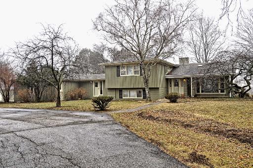 a big house with trees in front of it