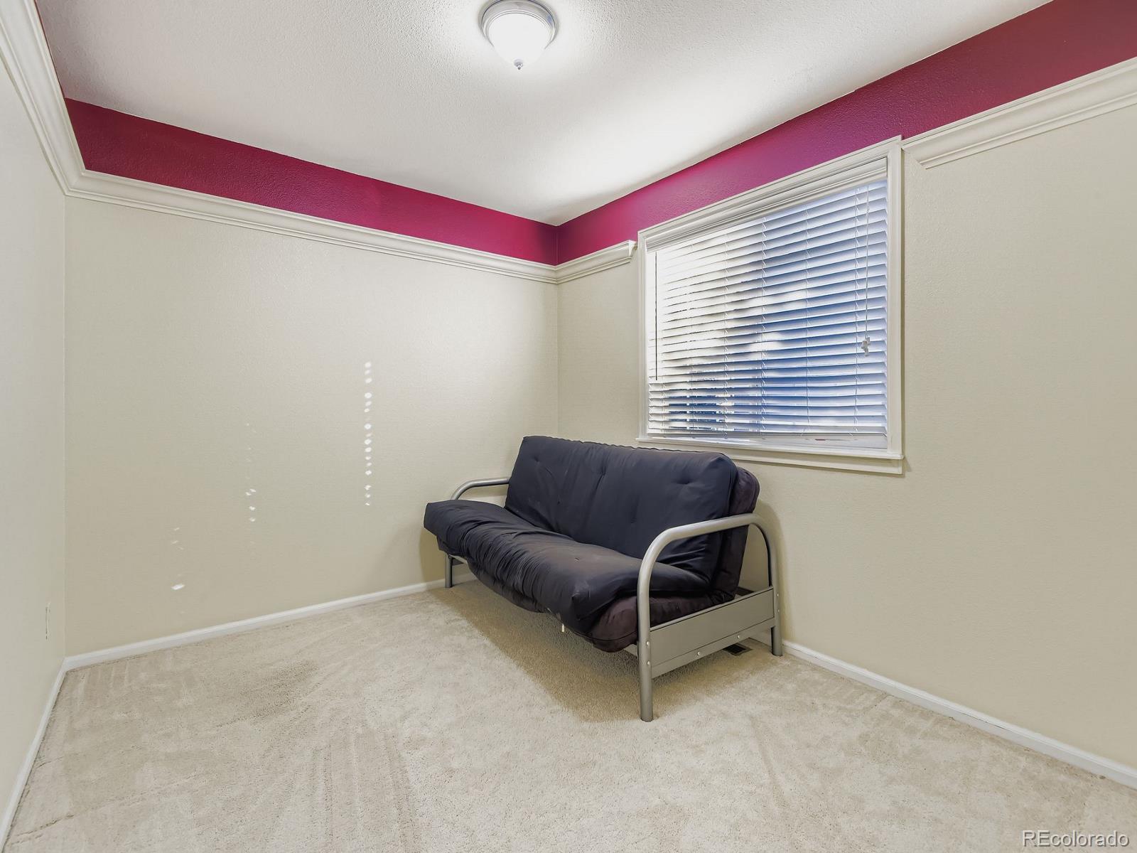 10036 Brisbane Lane Highlands Ranch, CO 80130 - Photo 19 of 27 a living room with furniture and a window