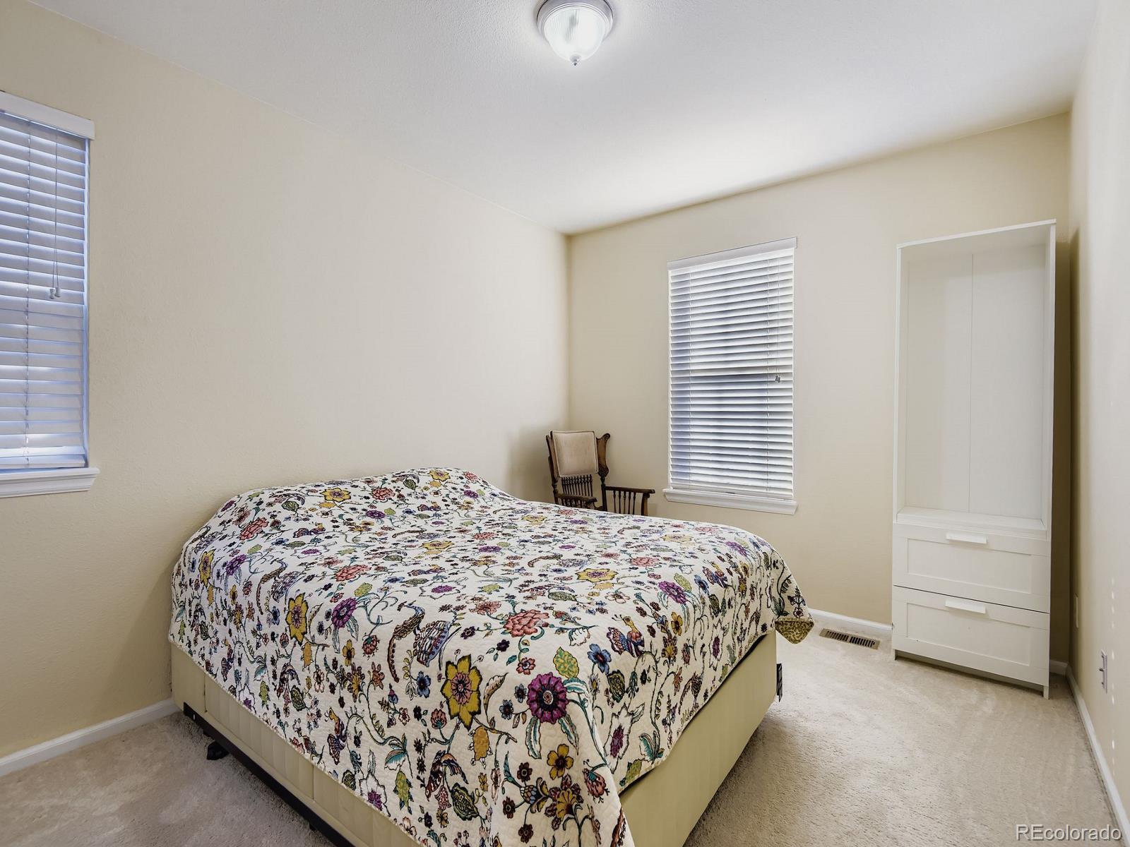 10036 Brisbane Lane Highlands Ranch, CO 80130 - Photo 20 of 27 a bedroom with a bed and a window