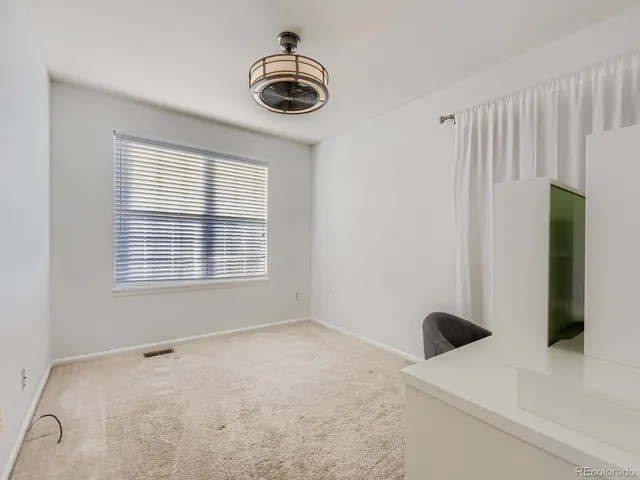 a bathroom with a granite countertop sink a toilet and a mirror