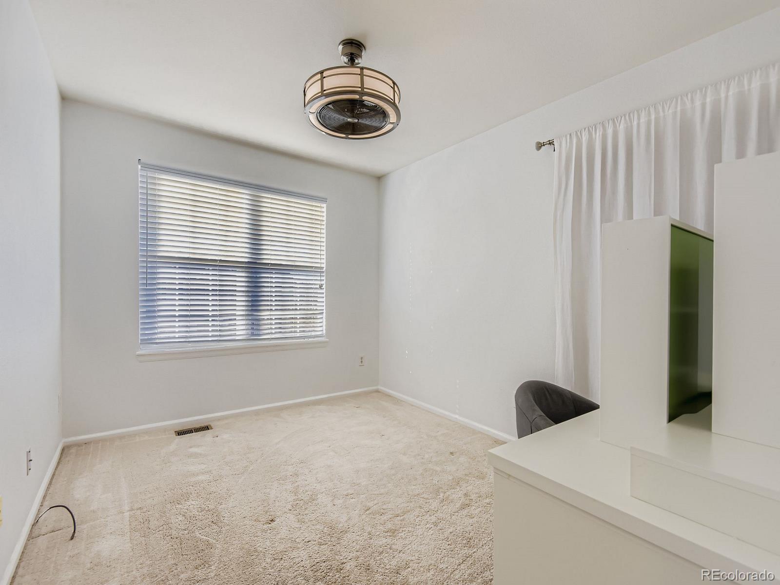 10036 Brisbane Lane Highlands Ranch, CO 80130 - Photo 21 of 27 a view of an empty room with a window