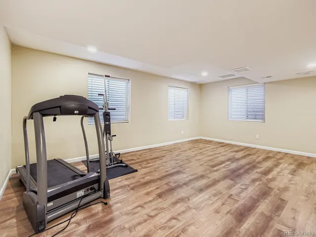 a bathroom with a toilet sink vanity and shower