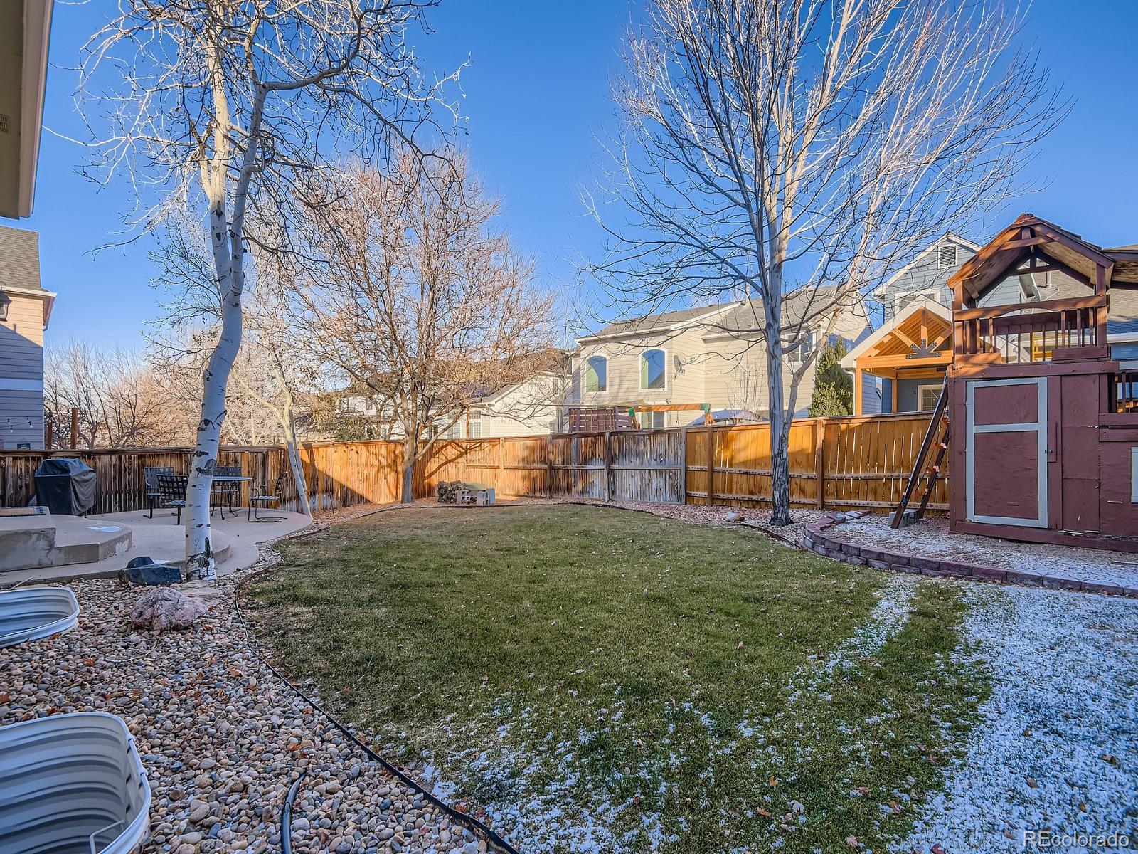 10036 Brisbane Lane Highlands Ranch, CO 80130 - Photo 25 of 27 a view of a yard in front of a house