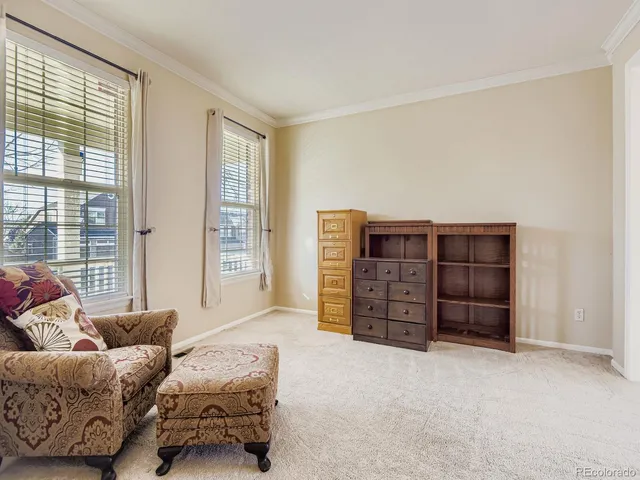 a living room with furniture cabinets and window