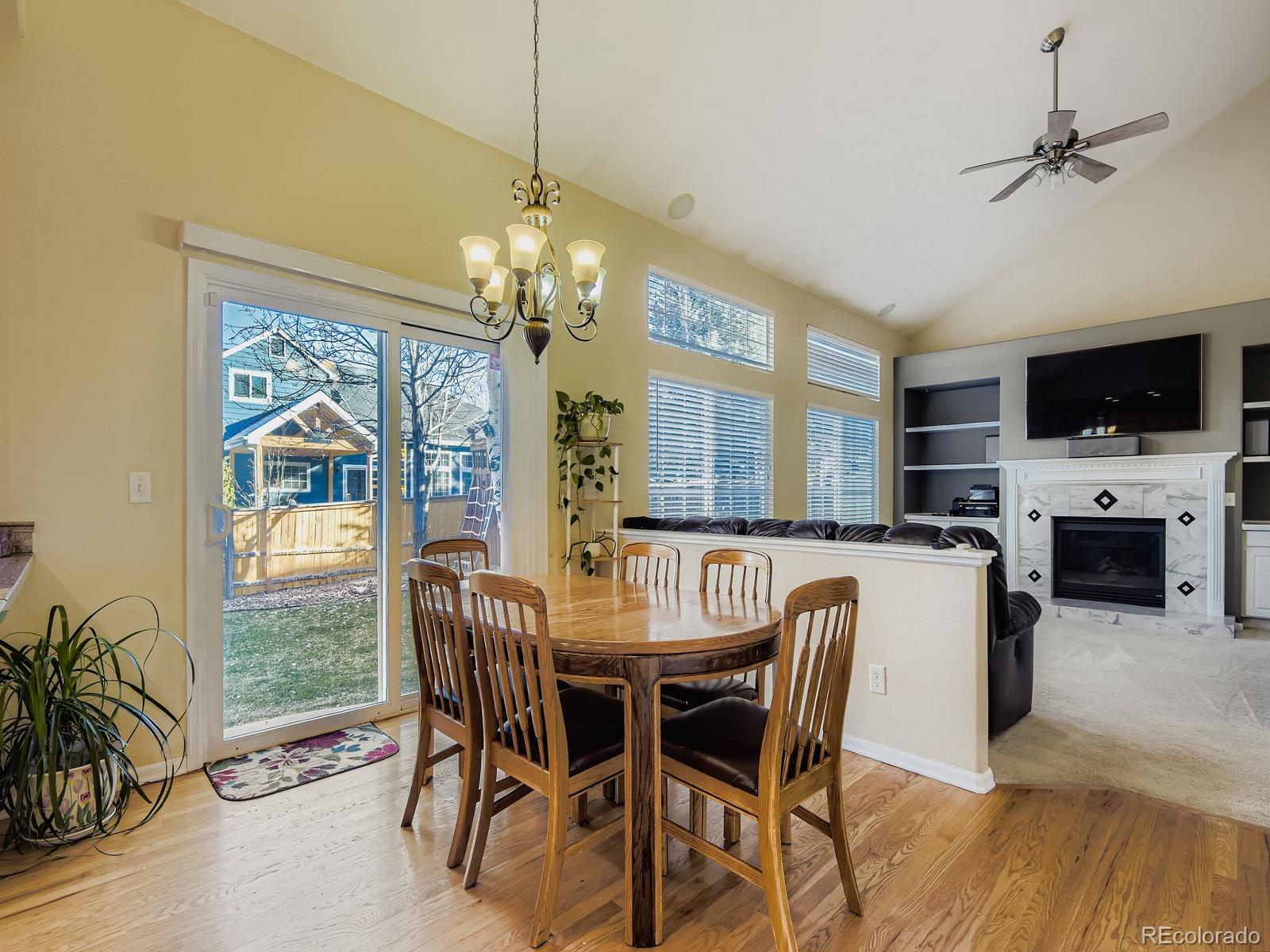 10036 Brisbane Lane Highlands Ranch, CO 80130 - Photo 10 of 27 a view of a dining room with furniture window and wooden floor