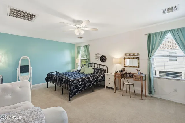 a bathroom with a sink a toilet a mirror a vanity and shower