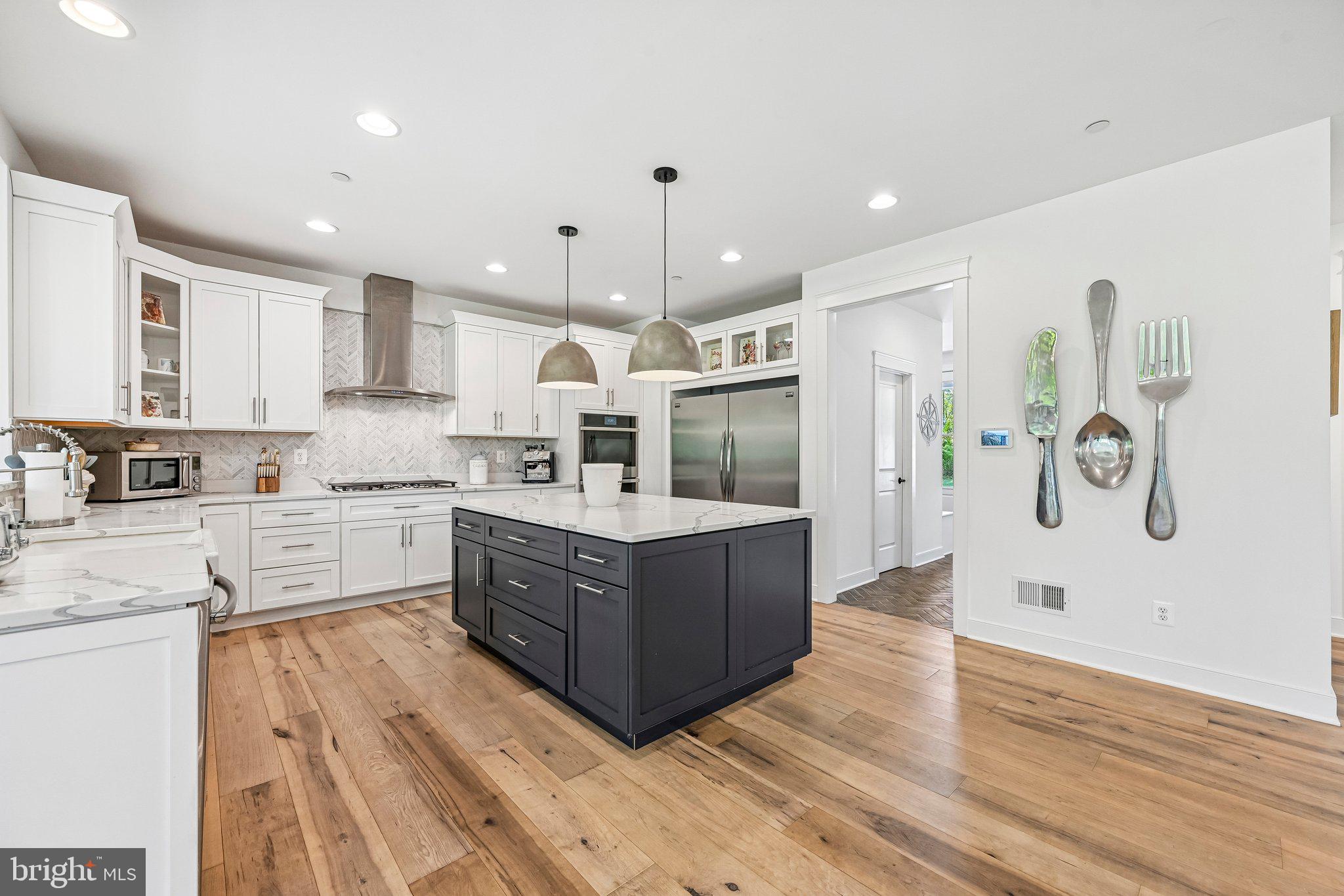14516 Old Frederick Road Cooksville, MD 21723 - Photo 18 of 100 a large kitchen with stainless steel appliances granite countertop a large center island a stove a refrigerator and a sink