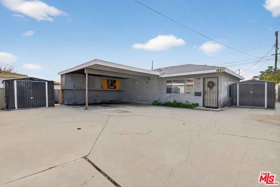 1416 255th Street Harbor City, CA 90710 - Photo 4 of 12 a view of a house with a yard and garage