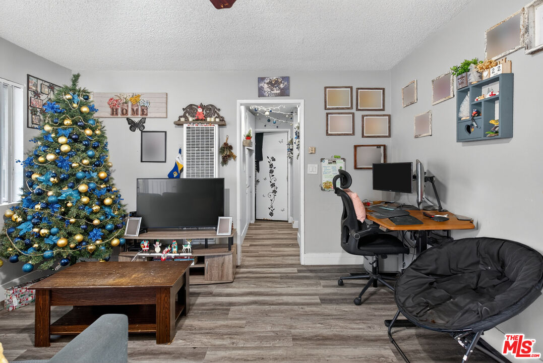 1416 255th Street Harbor City, CA 90710 - Photo 6 of 12 a view of a workspace with furniture and wooden floor