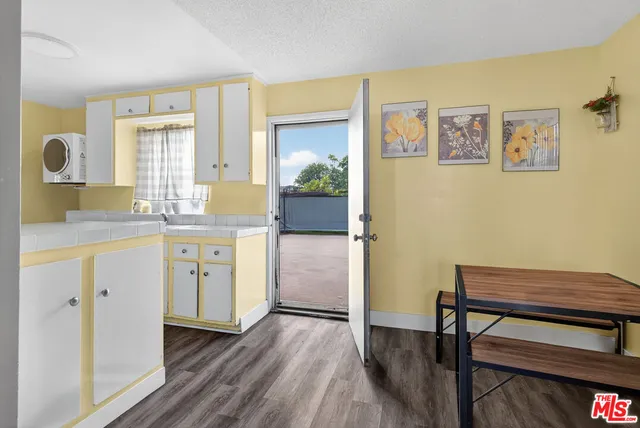 a kitchen with a sink and a stove top oven