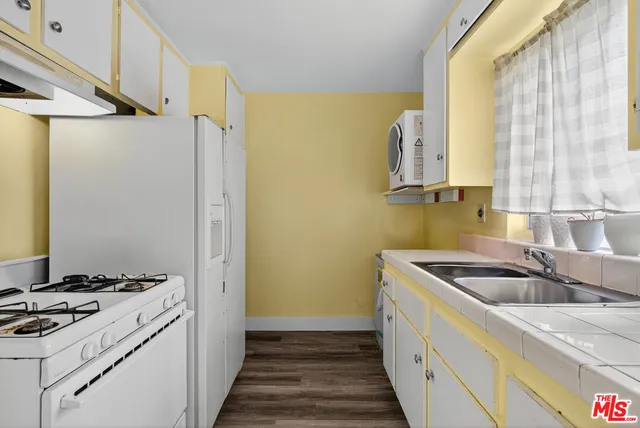 a living room with furniture a piano and a window