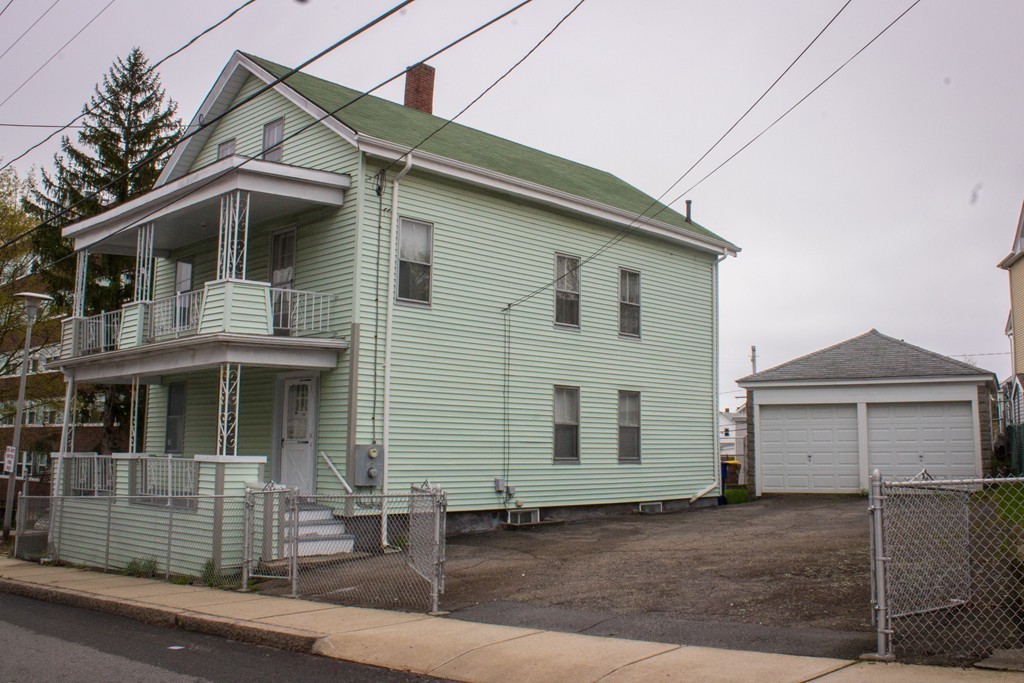 72 Whipple Street Fall River, MA 02721 - Photo 1 of 28 a front view of a house with garage