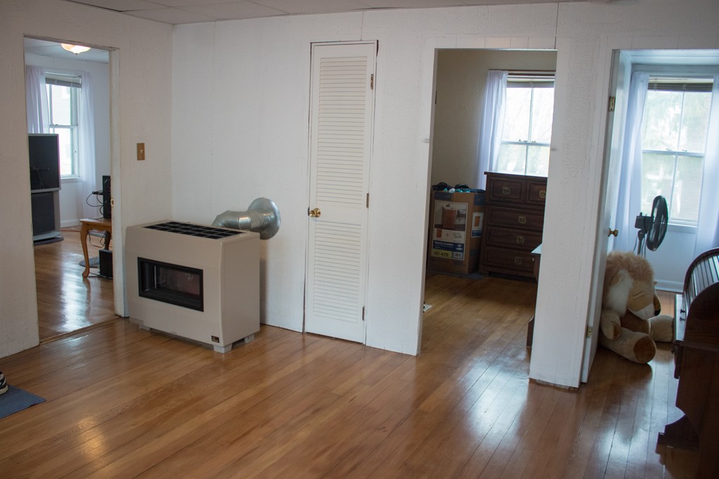 72 Whipple Street Fall River, MA 02721 - Photo 12 of 28 a view of a livingroom with furniture and a fireplace