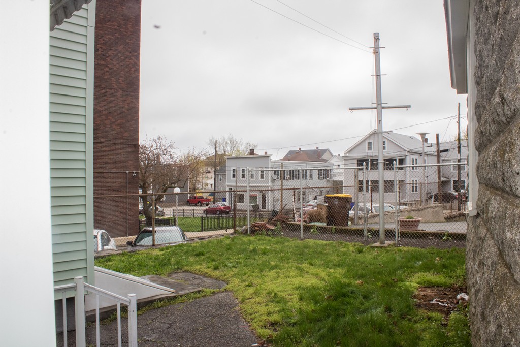 72 Whipple Street Fall River, MA 02721 - Photo 6 of 28 a front view of a house with a garden and plants