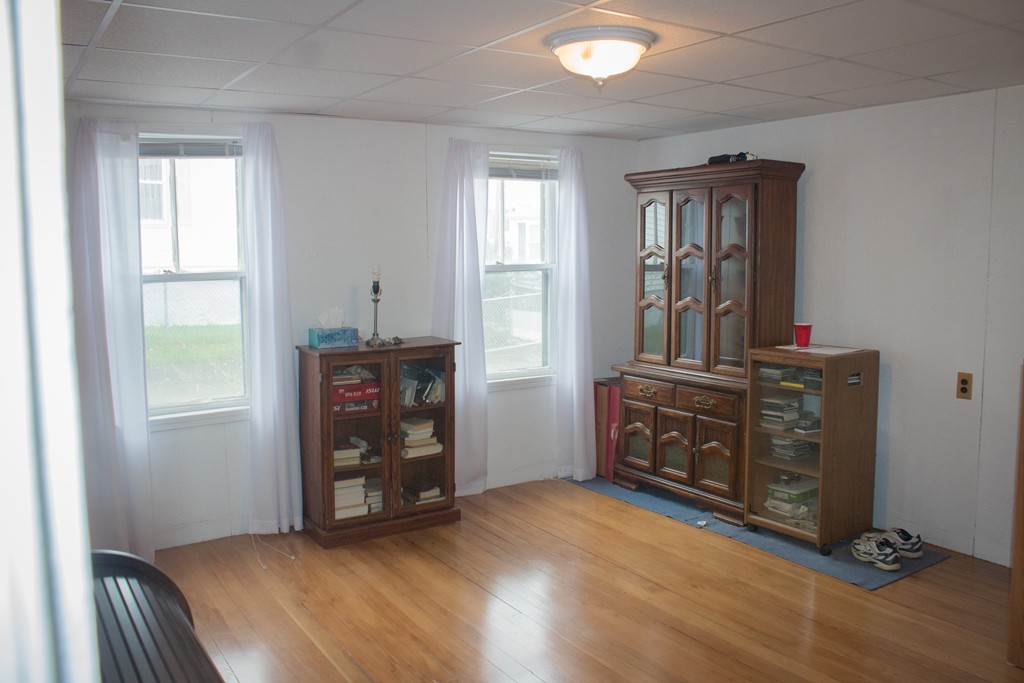 72 Whipple Street Fall River, MA 02721 - Photo 10 of 28 an empty room with windows and cabinet