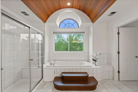 a bathroom with a toilet a bathtub and window