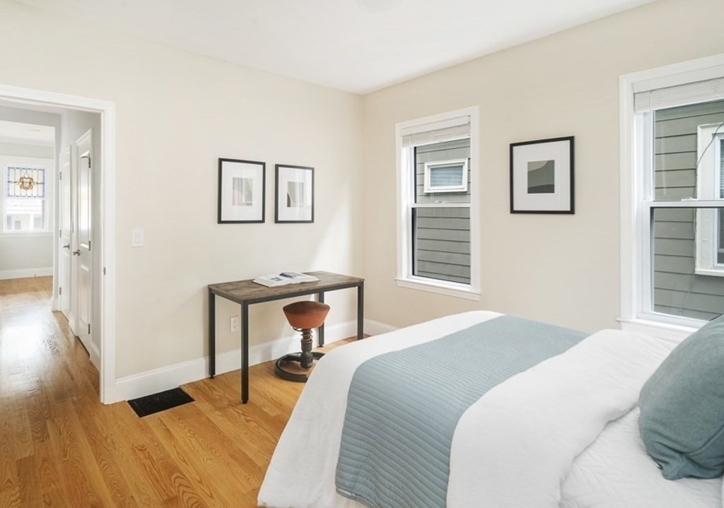 33 Bay State Avenue, Unit 1 Somerville, MA 02144 - Photo 12 of 23 a bedroom with a bed and a table