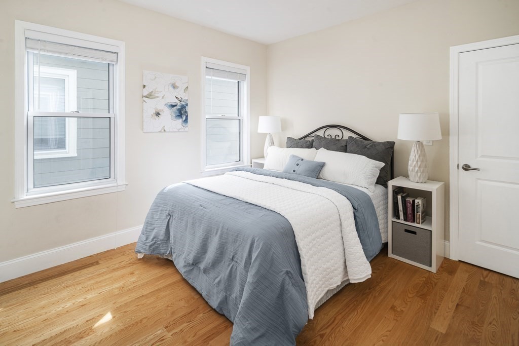 33 Bay State Avenue, Unit 1 Somerville, MA 02144 - Photo 13 of 23 a bedroom with a bed and window