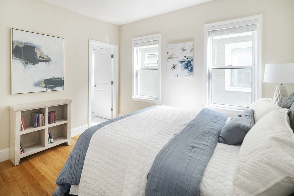 33 Bay State Avenue, Unit 1 Somerville, MA 02144 - Photo 14 of 23 a bedroom with a bed and a window