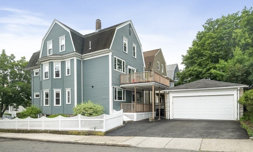 33 Bay State Avenue, Unit 1 Somerville, MA 02144 - Photo 18 of 23 a front view of a house with a garden