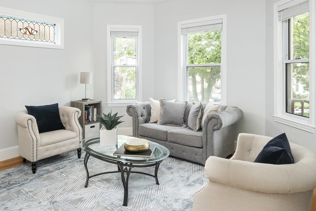 33 Bay State Avenue, Unit 1 Somerville, MA 02144 - Photo 5 of 23 a living room with furniture and a large window