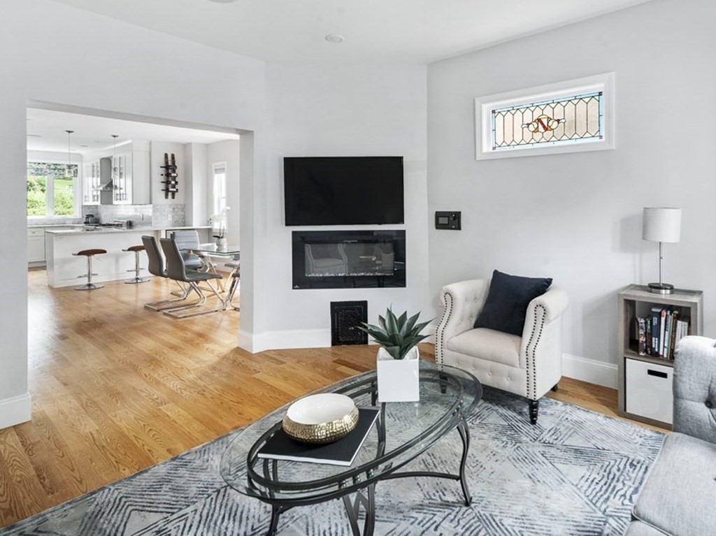33 Bay State Avenue, Unit 1 Somerville, MA 02144 - Photo 6 of 23 a living room with furniture a flat screen tv and a lamp