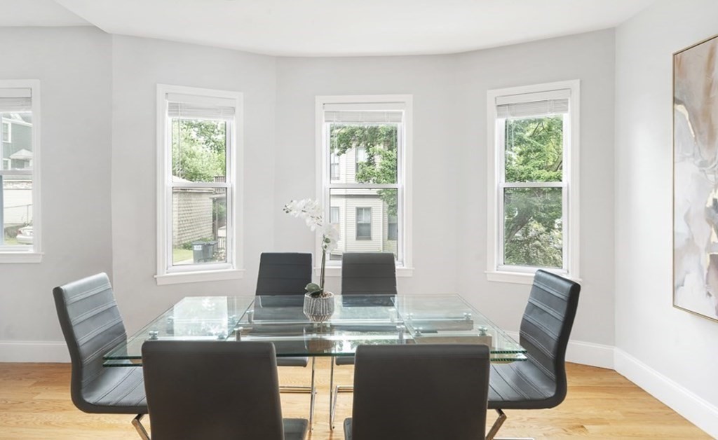 33 Bay State Avenue, Unit 1 Somerville, MA 02144 - Photo 7 of 23 a dining room with furniture window and wooden floor