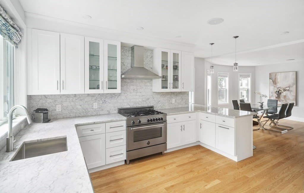 33 Bay State Avenue, Unit 1 Somerville, MA 02144 - Photo 10 of 23 a kitchen with a sink stove and cabinets