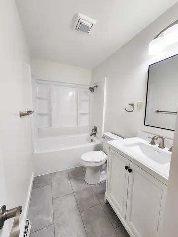 a bathroom with a toilet sink and a mirror